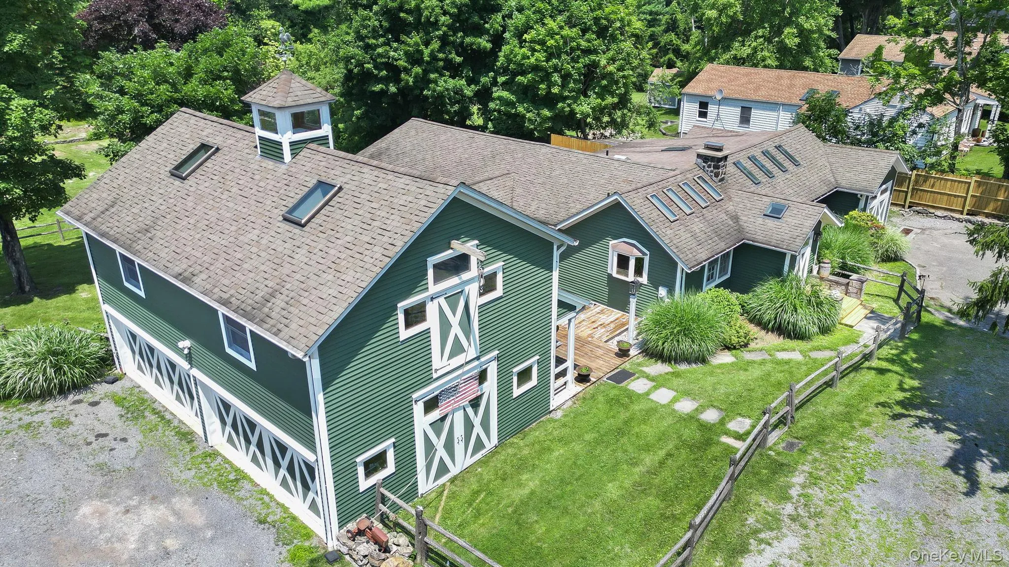 Featuring a multi-gabled roofline and multiple skylights. Featuring a multi-gabled roofline and multiple skylights.