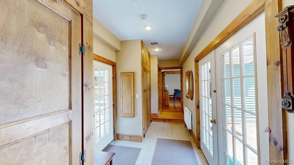 Breezeway Entry - Foyerwith Double French Doors entering and exiting the foyer. Breezeway Entry - Foyerwith Double French Doors entering and exiting the foyer.