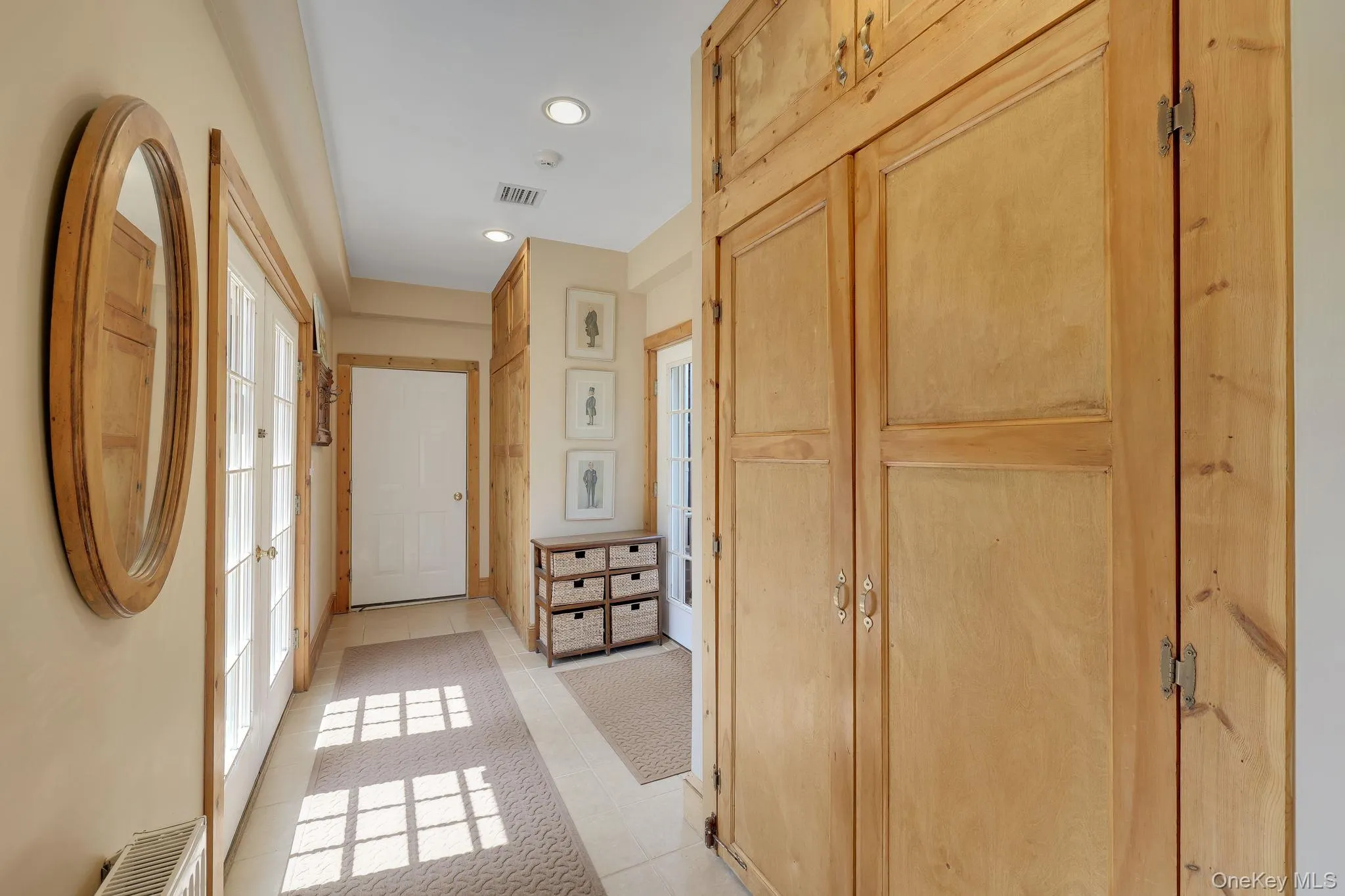 Foyer Hallway with extensive built-in wooden cabinetry, recessed lighting, and tile flooring. Foyer Hallway with extensive built-in wooden cabinetry, recessed lighting, and tile flooring.