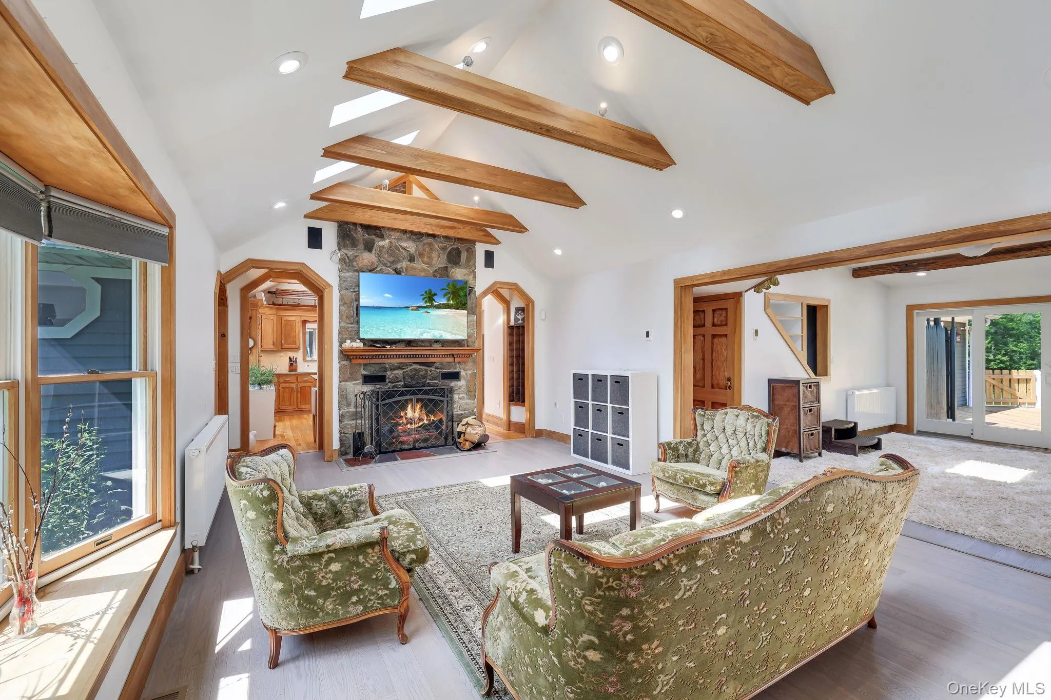Living Room with vaulted ceilings with exposed wood beams, skylights, and recessed lighting. Open to the Family Room Living Room with vaulted ceilings with exposed wood beams, skylights, and recessed lighting. Open to the Family Room