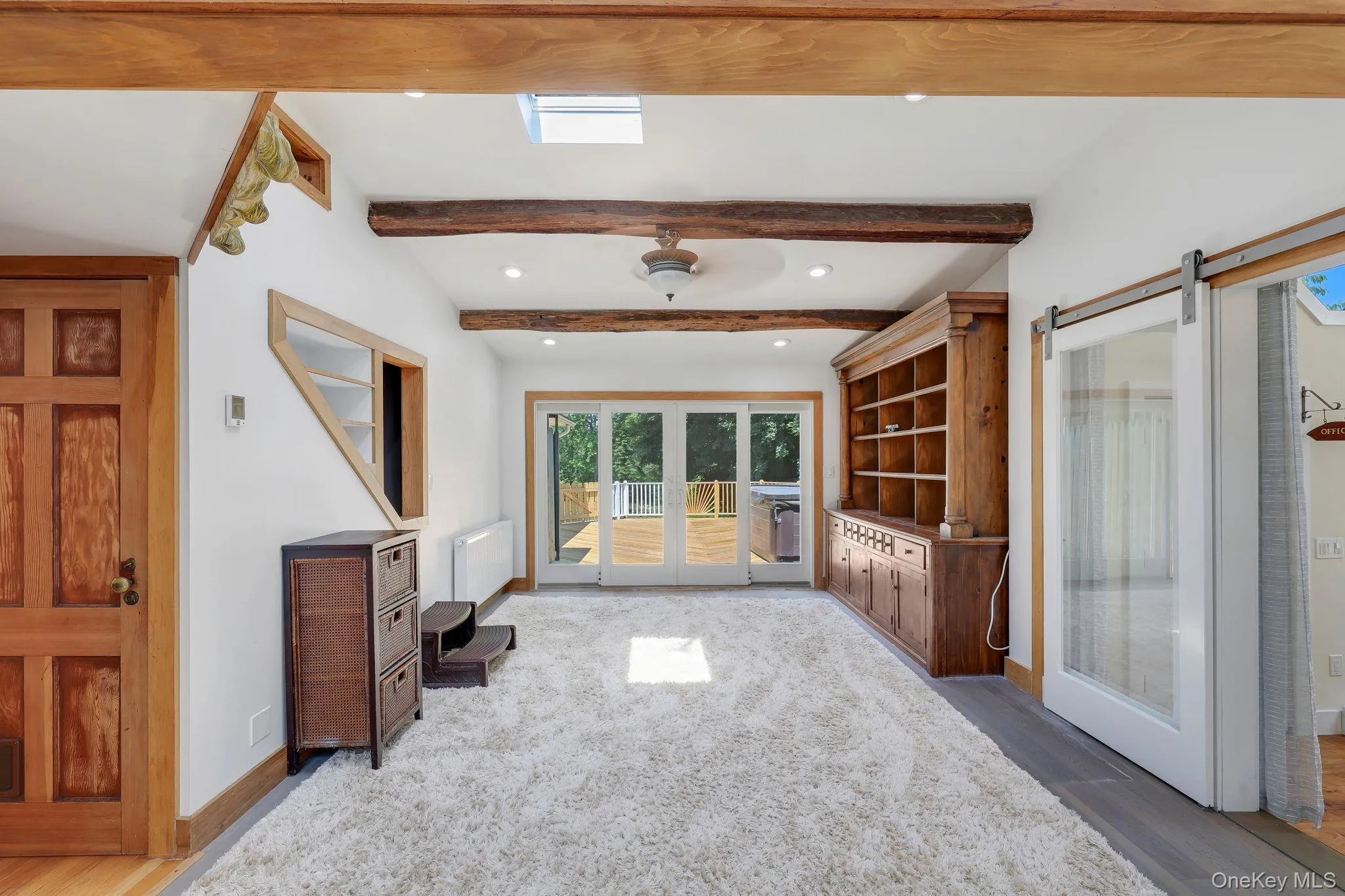 Family Room with sliding glass doors leading to back deck with hot tub and outdoor shower. Family Room with sliding glass doors leading to back deck with hot tub and outdoor shower.