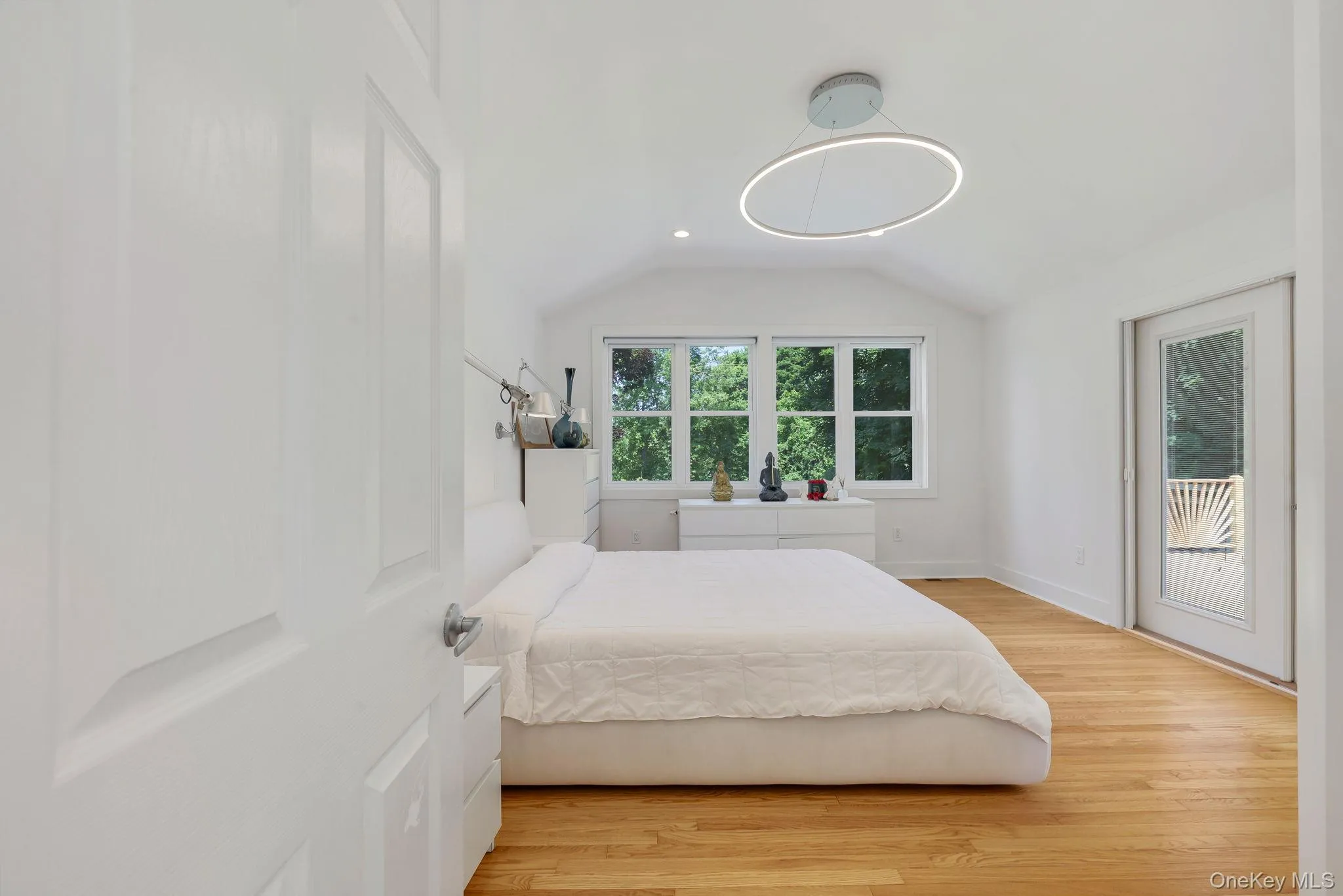 Primary Bedroom with hardwood floors and French doors leading to private deck with Hot Tub and outdoor shower Primary Bedroom with hardwood floors and French doors leading to private deck with Hot Tub and outdoor shower