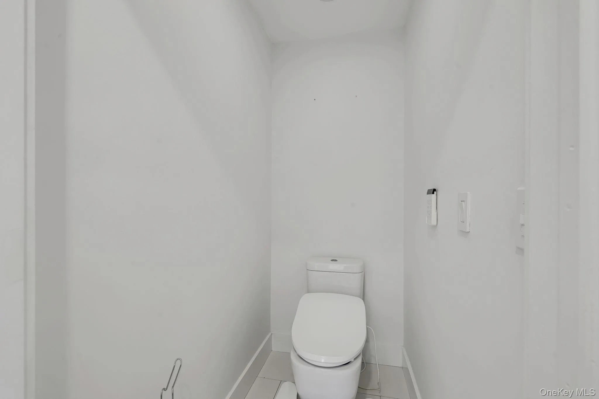 Primary Water Closet with remote to operate comfort features of heated seat and bidet functions Primary Water Closet with remote to operate comfort features of heated seat and bidet functions