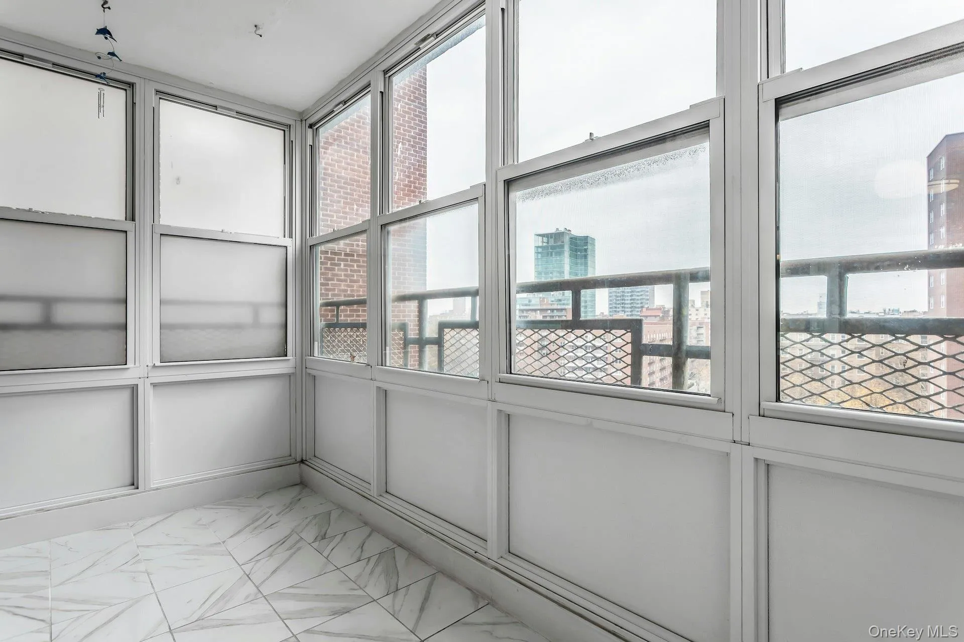 Unfurnished sunroom featuring a city view Unfurnished sunroom featuring a city view