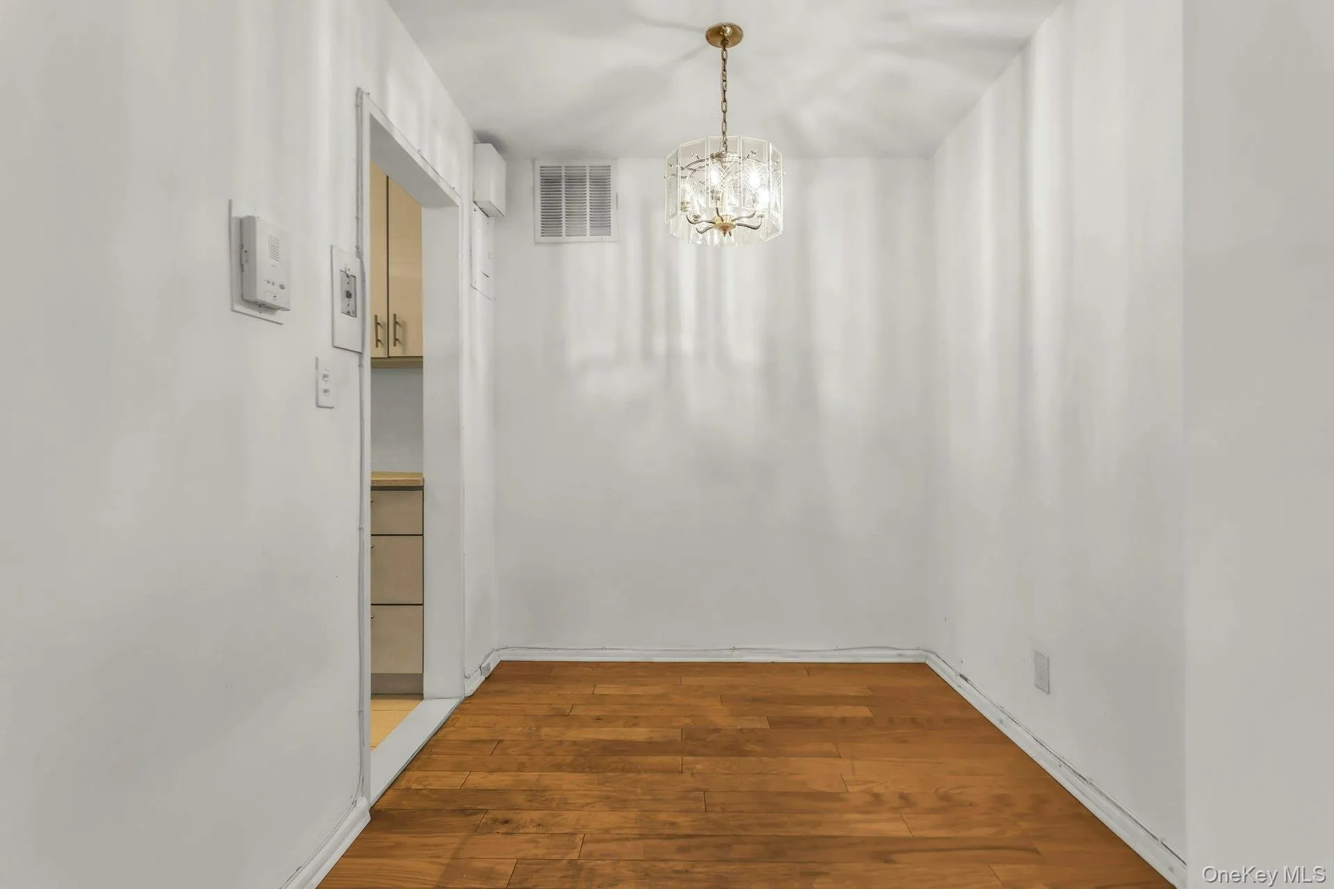 Unfurnished dining area featuring light wood-style floors and a chandelier Unfurnished dining area featuring light wood-style floors and a chandelier