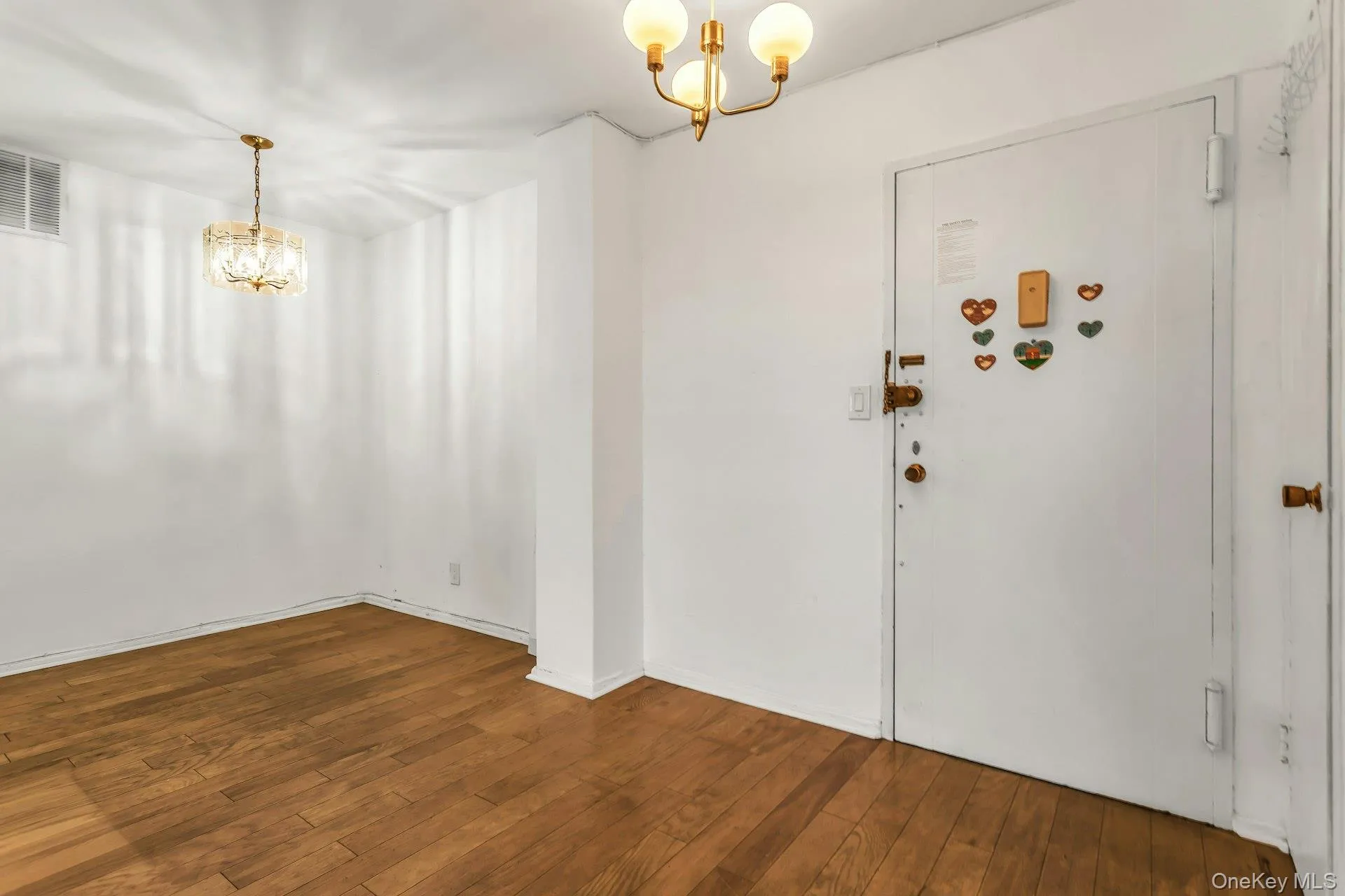 Entryway with a chandelier and dark wood-style floors Entryway with a chandelier and dark wood-style floors
