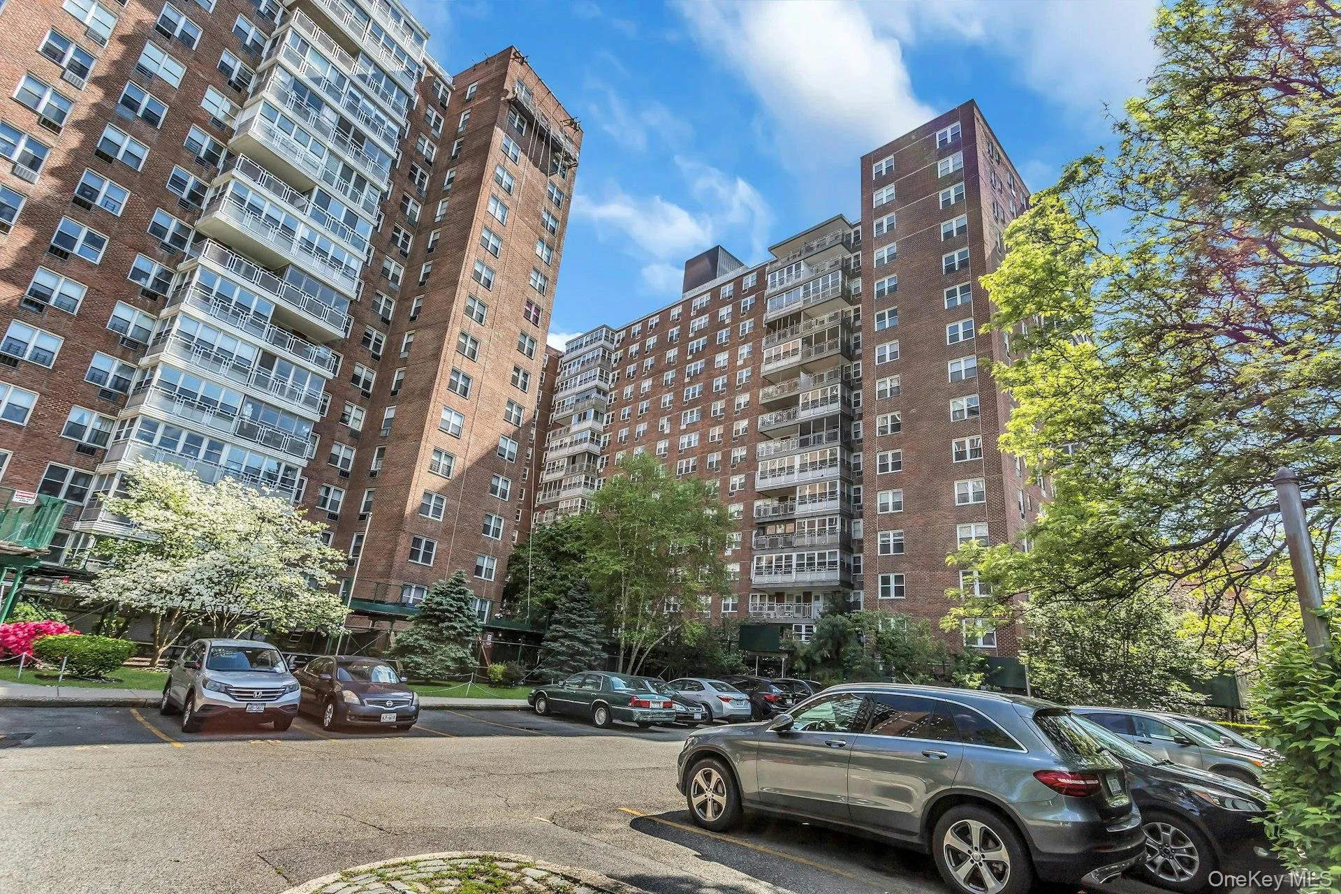 View of apartment building / complex with uncovered parking View of apartment building / complex with uncovered parking