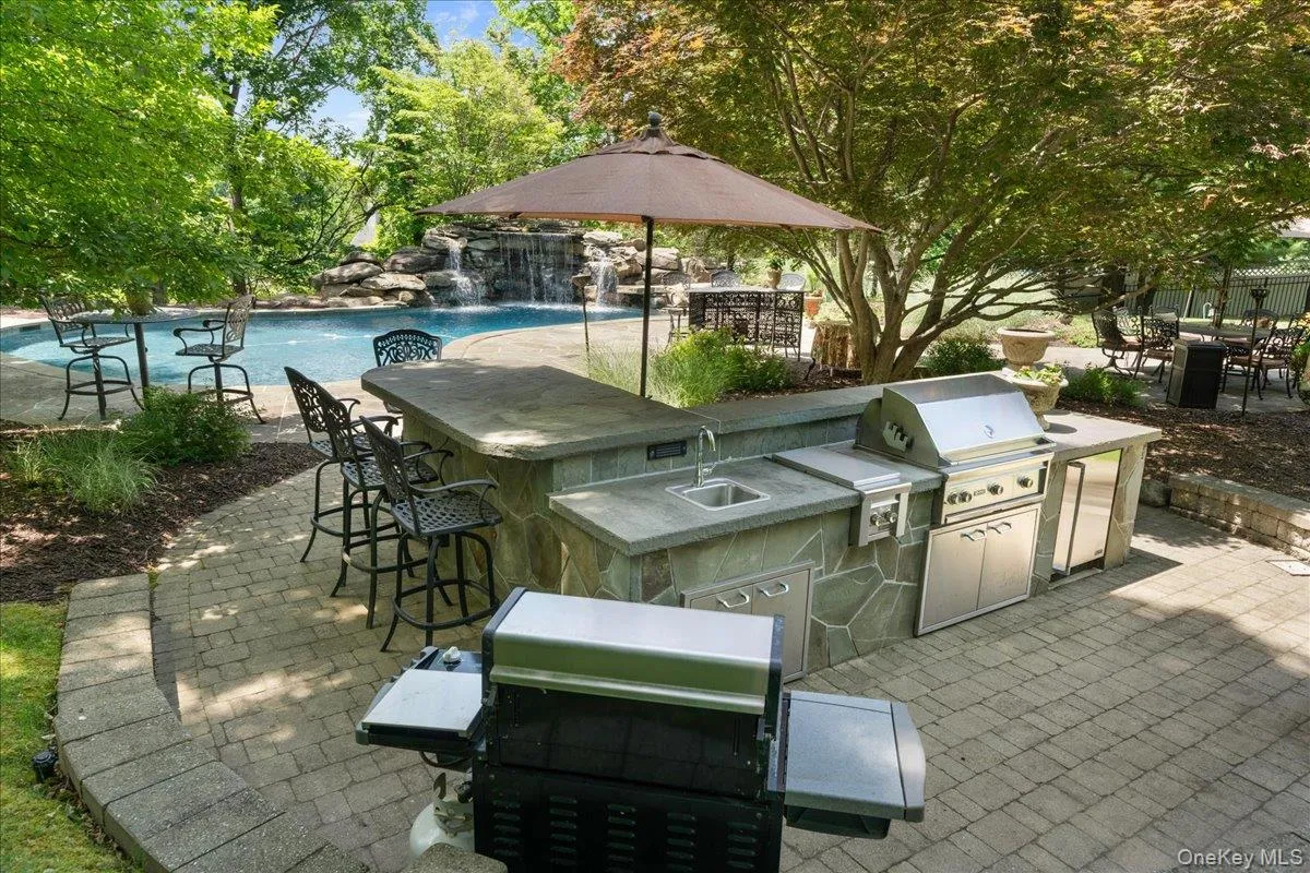 Enhanced by an inviting L-shaped seating area, this outdoor space is ideal for dining, entertaining, and gathering with family and friends. Enhanced by an inviting L-shaped seating area, this outdoor space is ideal for dining, entertaining, and gathering with family and friends.