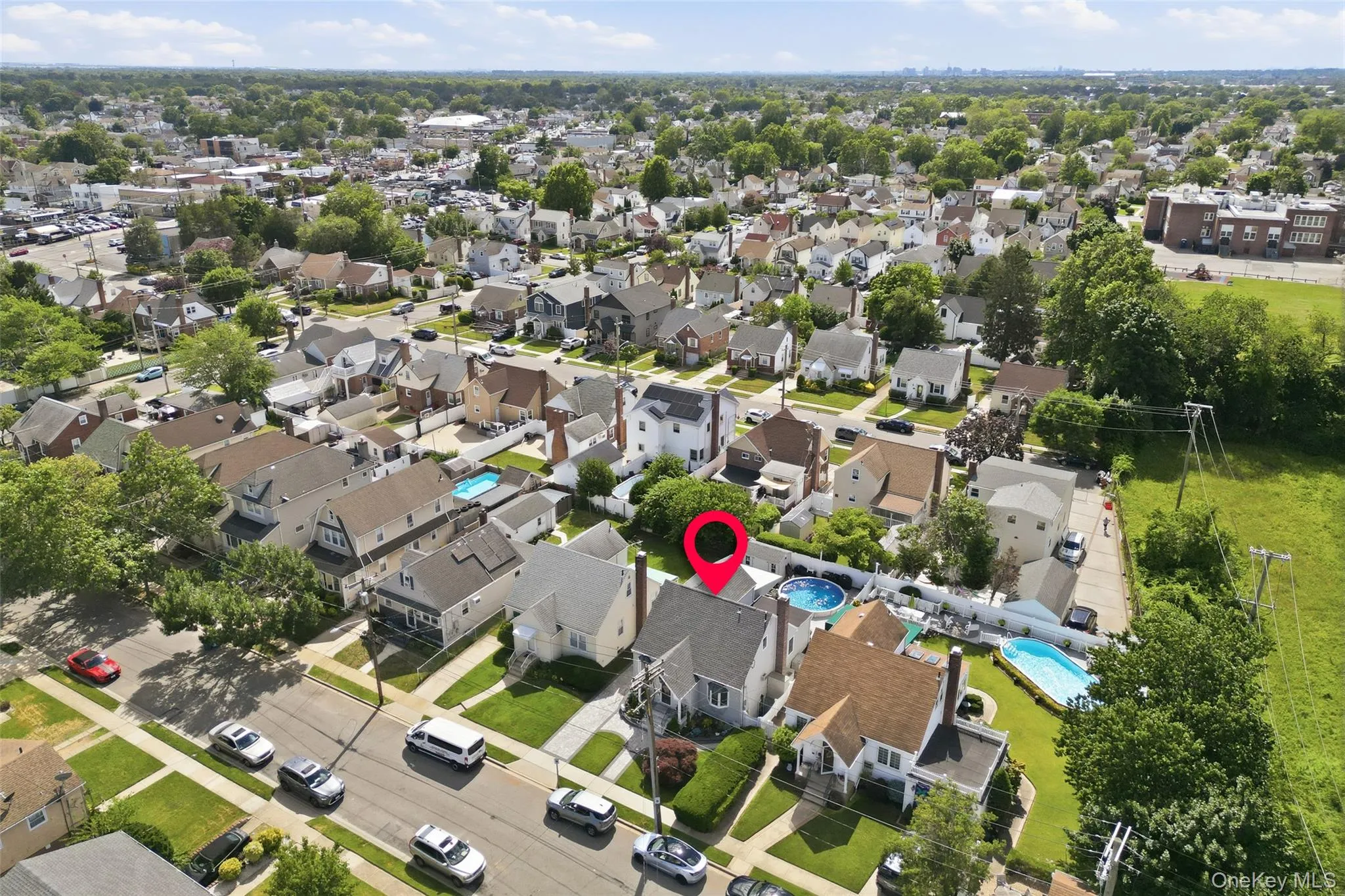 Aerial perspective of a residential neighborhood featuring detached homes on tree-lined streets Aerial perspective of a residential neighborhood featuring detached homes on tree-lined streets