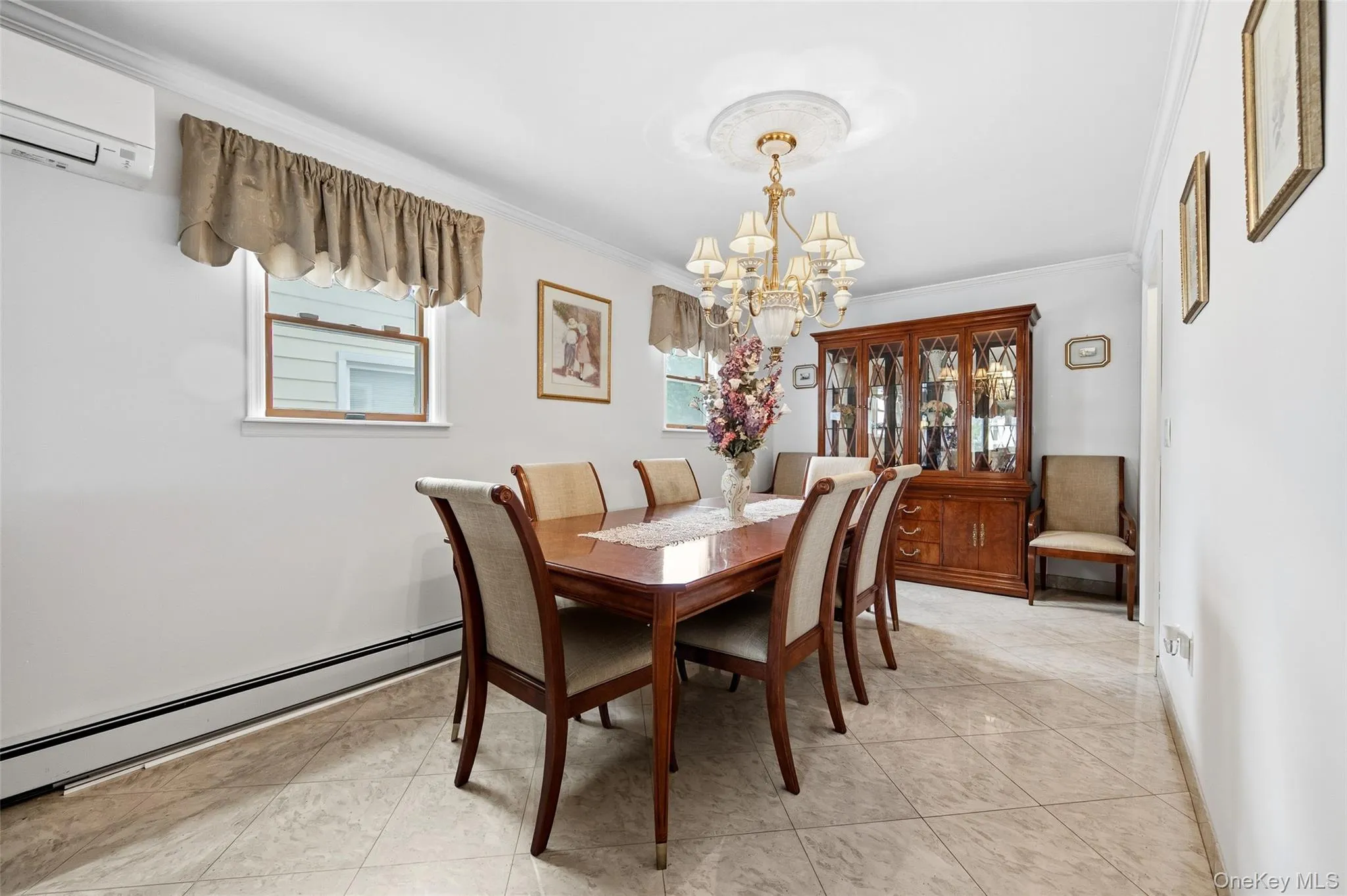 Dining area featuring tile flooring, a decorative ceiling medallion, and crown molding Dining area featuring tile flooring, a decorative ceiling medallion, and crown molding