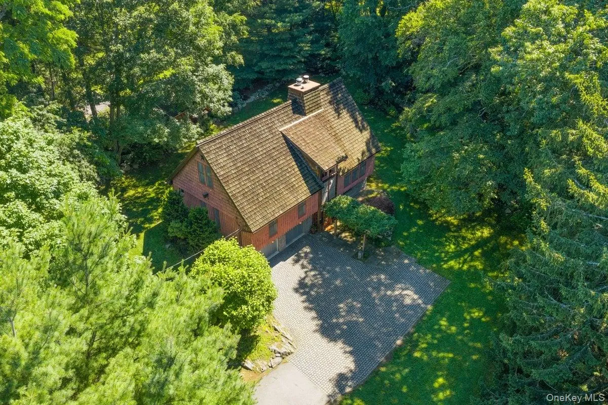 Aerial view highlights the courtyard, house, and natural surroundings. Aerial view highlights the courtyard, house, and natural surroundings.