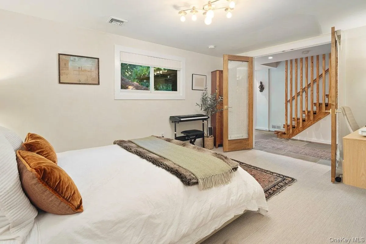 Through French doors on the entry level is a spacious bonus room, which can be used as a bedroom, office, or guest suite. Through French doors on the entry level is a spacious bonus room, which can be used as a bedroom, office, or guest suite.