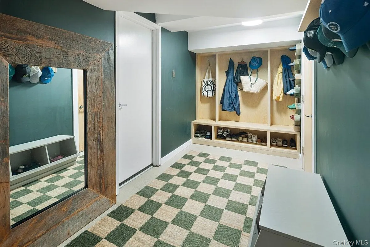 The newly renovated and expanded mudroom on the entry level features custom coat cubbies, a spacious coat and storage closet, and convenient access to the laundry room and garage. The newly renovated and expanded mudroom on the entry level features custom coat cubbies, a spacious coat and storage closet, and convenient access to the laundry room and garage.