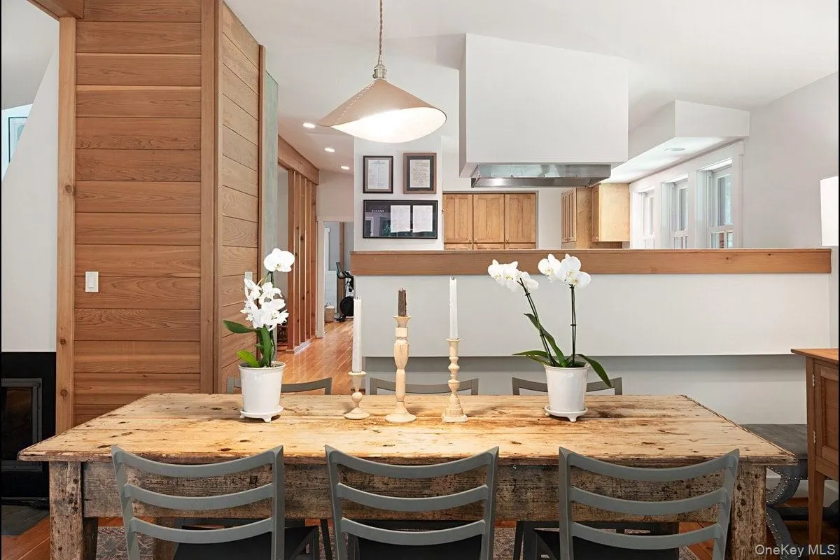 View from the dining area into the kitchen and hallway. Notice the harmonious blend of wood, light, clean lines, and open space. View from the dining area into the kitchen and hallway. Notice the harmonious blend of wood, light, clean lines, and open space.