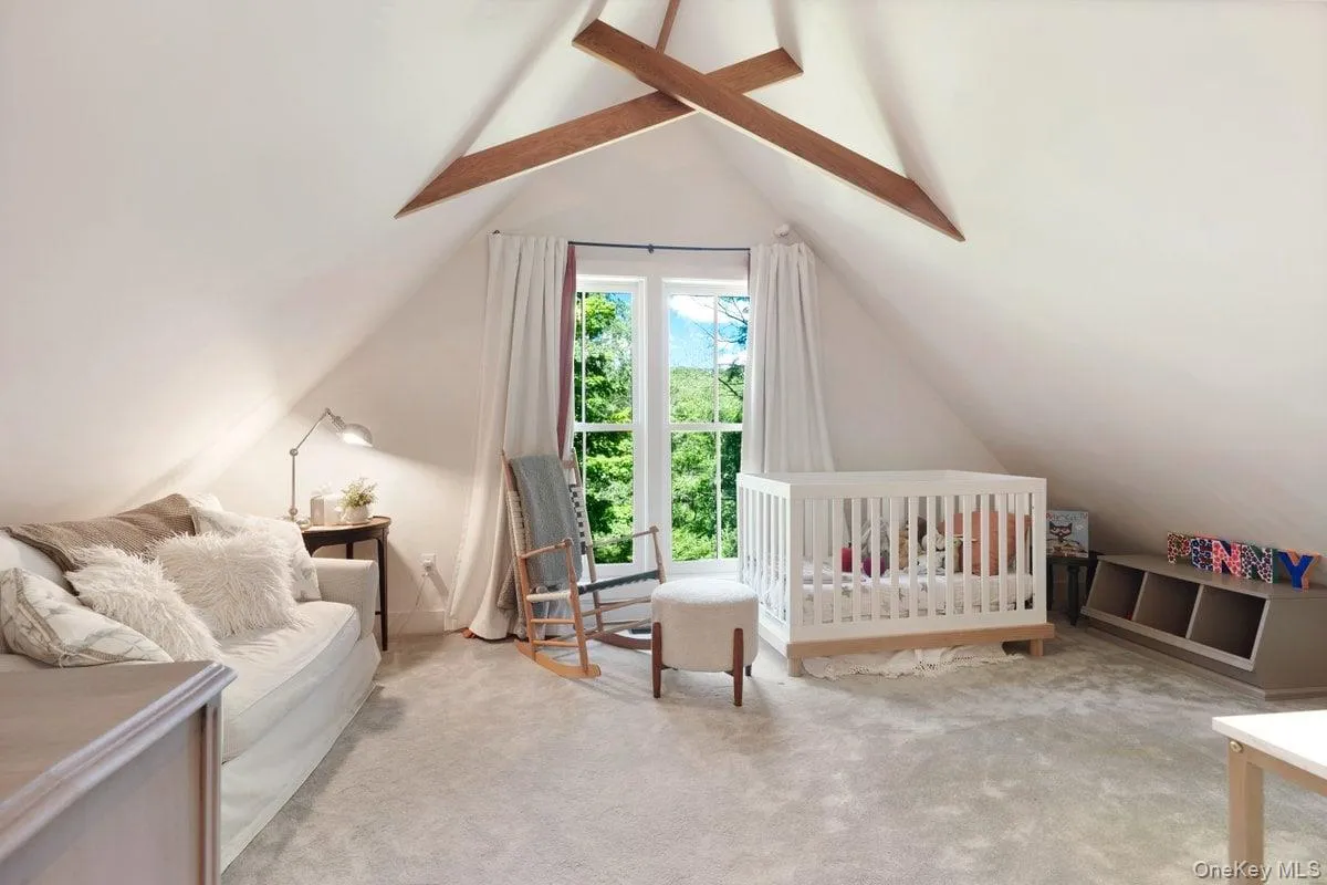 Sunlight-filled second floor bedroom with wood-beamed vaulted ceiling, large closets, and soft carpet. Sunlight-filled second floor bedroom with wood-beamed vaulted ceiling, large closets, and soft carpet.