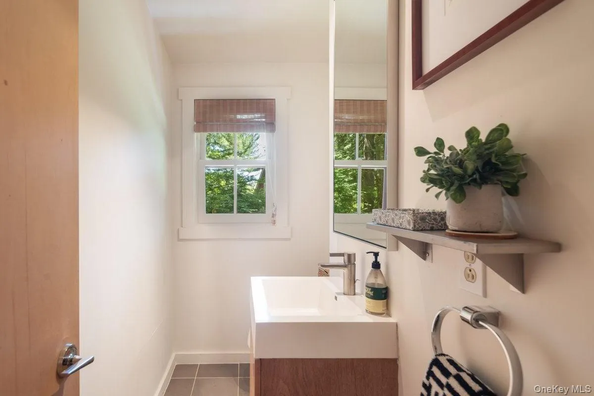 The half bath on the main level is convenient and features the same design elements as the rest of the home. The half bath on the main level is convenient and features the same design elements as the rest of the home.