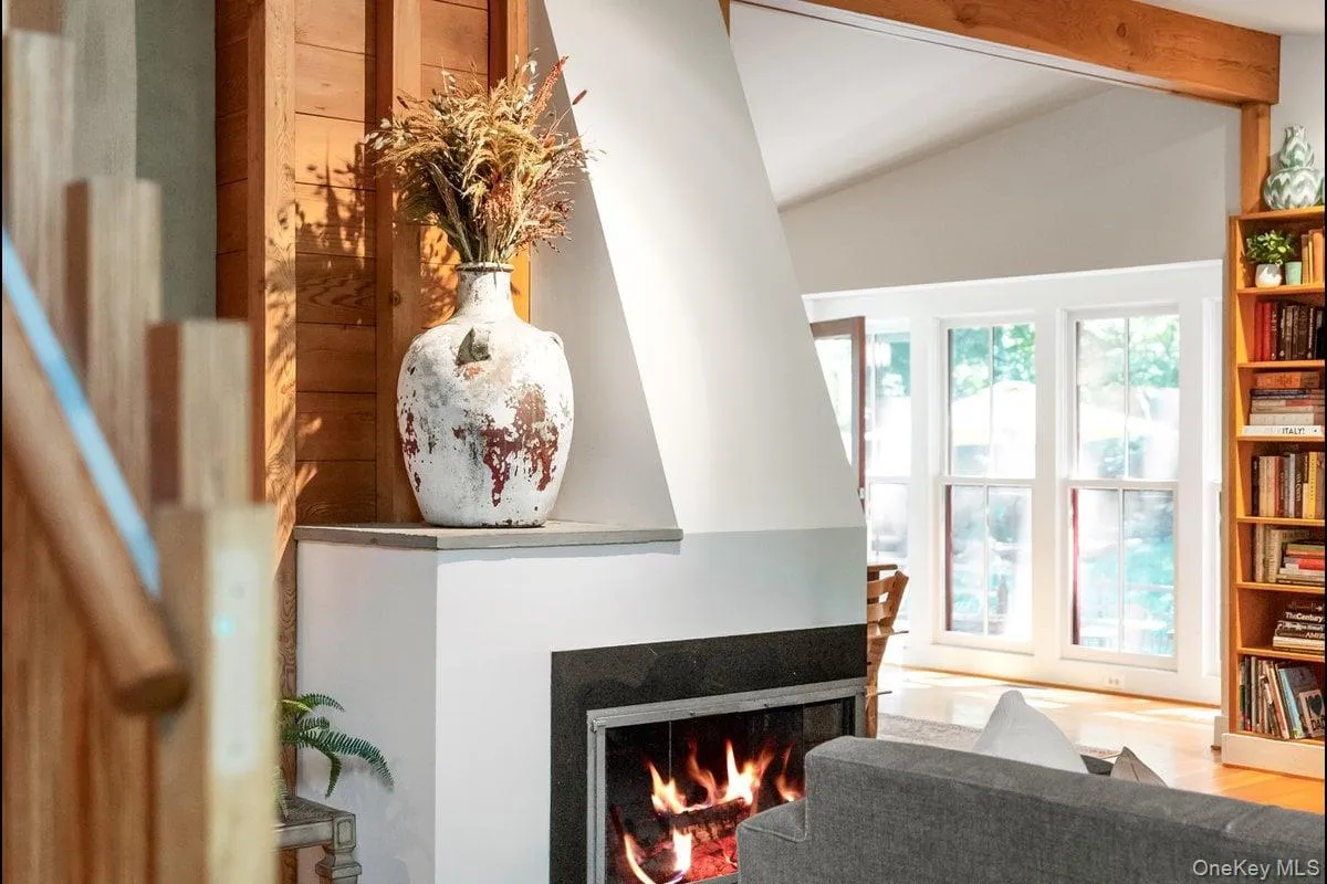 Beyond the stunning fireplace, the dining area unfolds with a wall of windows that invites the sunlight to pour in. Beyond the stunning fireplace, the dining area unfolds with a wall of windows that invites the sunlight to pour in.