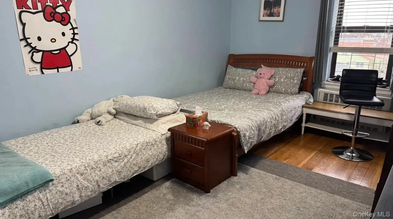 Bedroom featuring wood finished floors Bedroom featuring wood finished floors