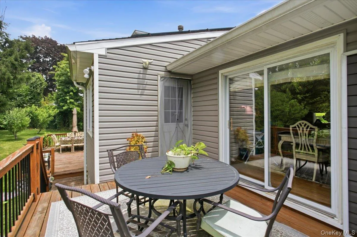 Spacious outdoor deck featuring natural wood decking and railings Spacious outdoor deck featuring natural wood decking and railings
