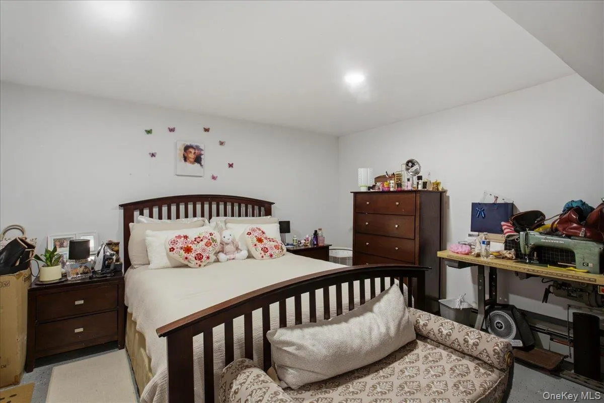 Spacious bedroom and bath on lower level featuring light-toned walls and ceiling, recessed lighting, and durable flooring with a den area with a kitchenette. Private entrance through the garage. Spacious bedroom and bath on lower level featuring light-toned walls and ceiling, recessed lighting, and durable flooring with a den area with a kitchenette. Private entrance through the garage.