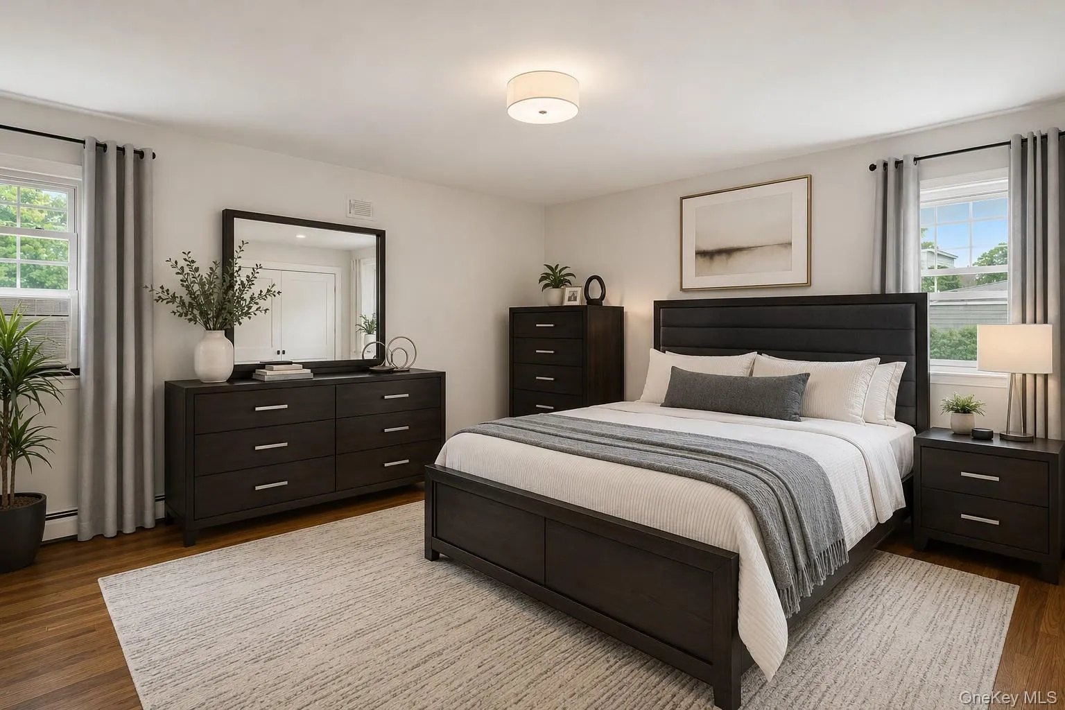 Hardwood-style flooring, white walls, and a semi-flush mount ceiling light Hardwood-style flooring, white walls, and a semi-flush mount ceiling light