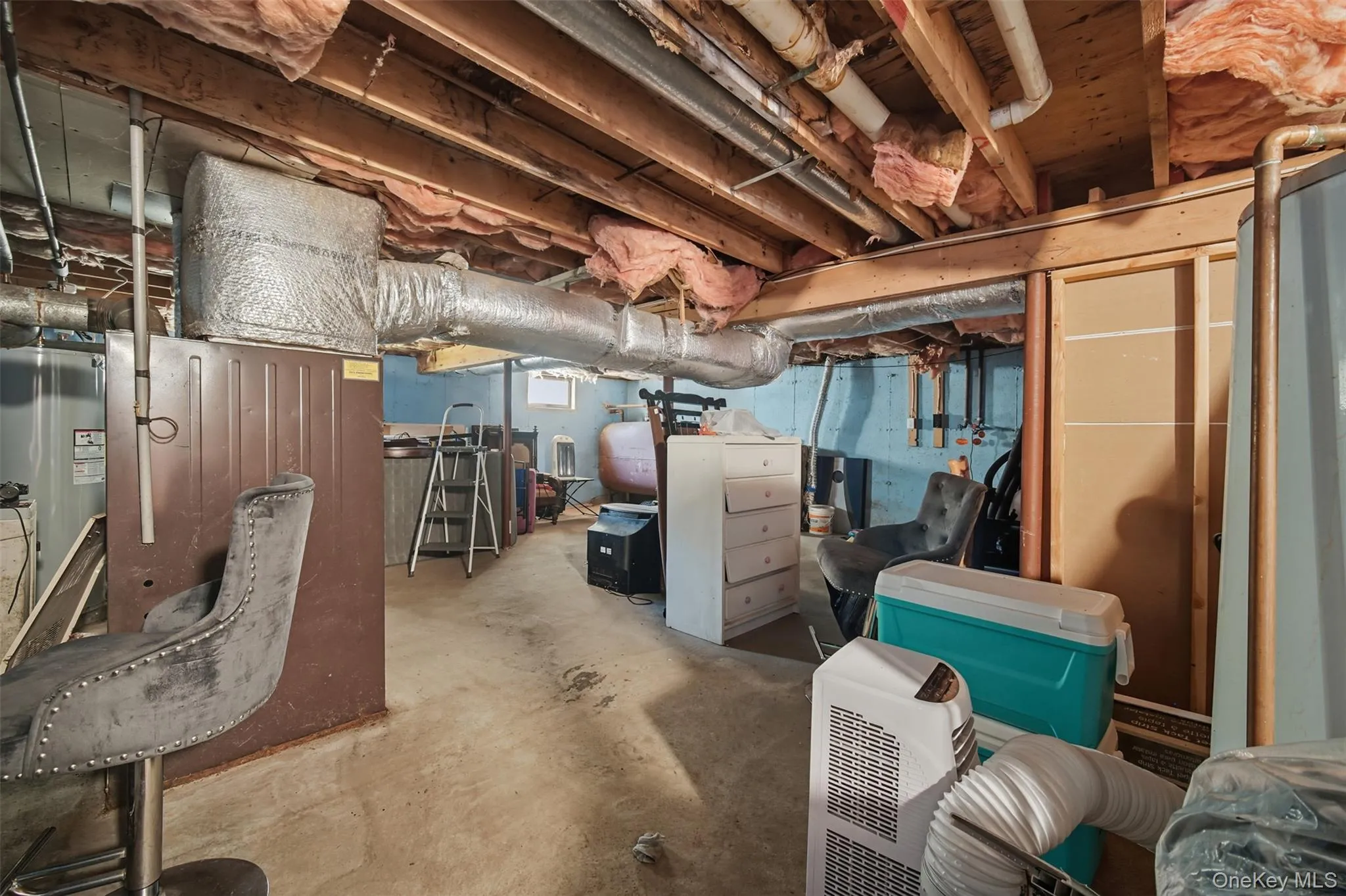 Below grade area featuring heating fuel and electric water heater Below grade area featuring heating fuel and electric water heater