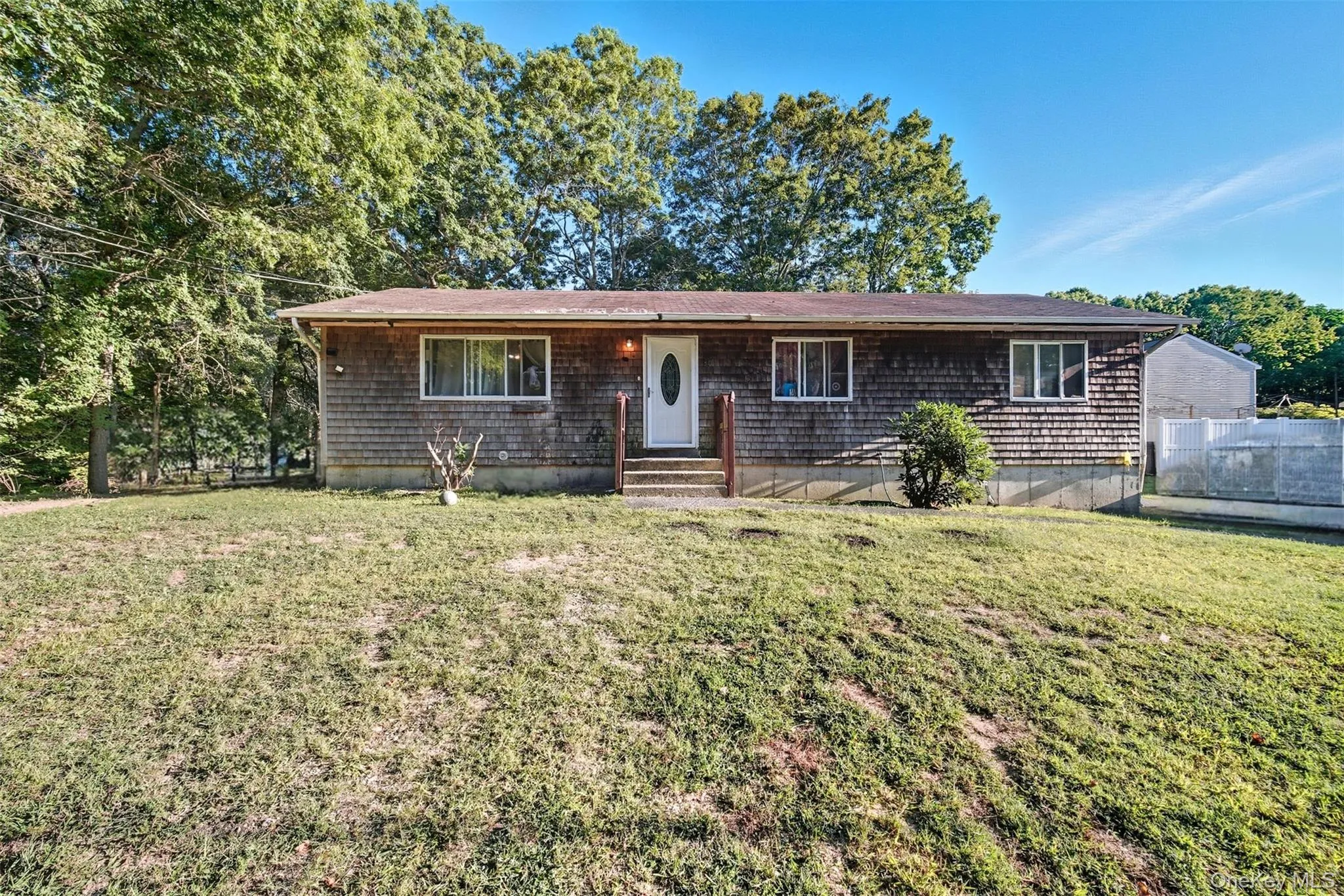Ranch-style home featuring a front lawn Ranch-style home featuring a front lawn