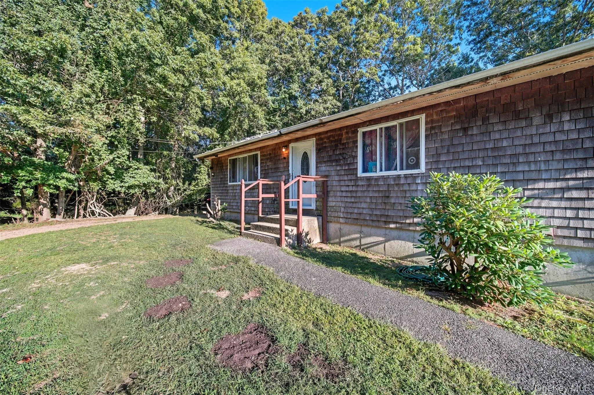 Single story home featuring a front yard Single story home featuring a front yard