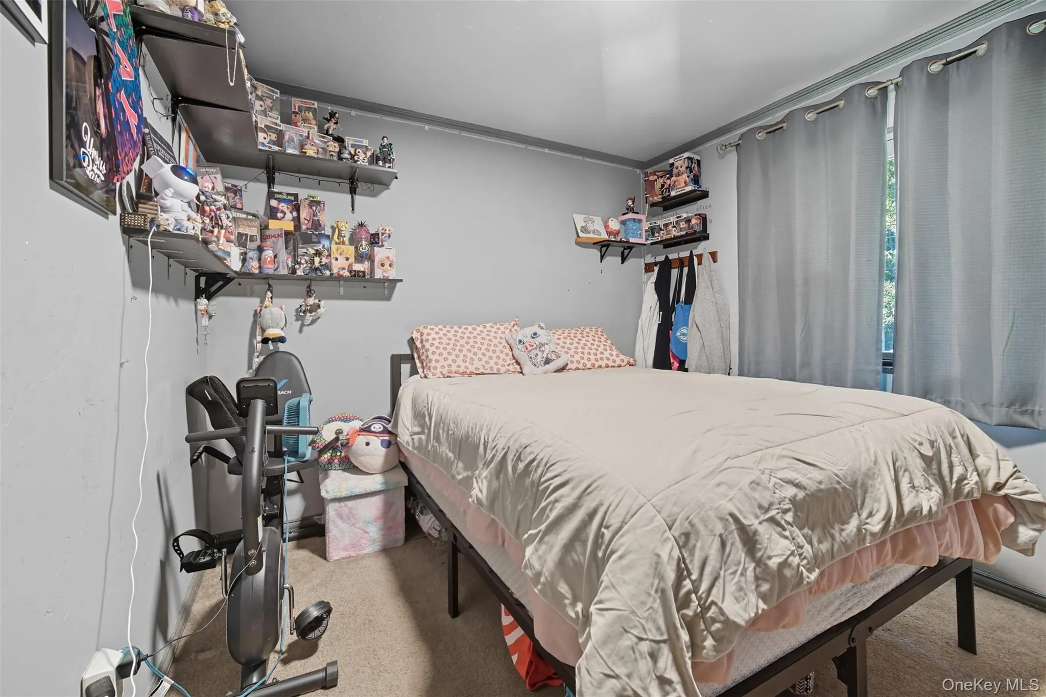 Bedroom with ornamental molding and light carpet Bedroom with ornamental molding and light carpet