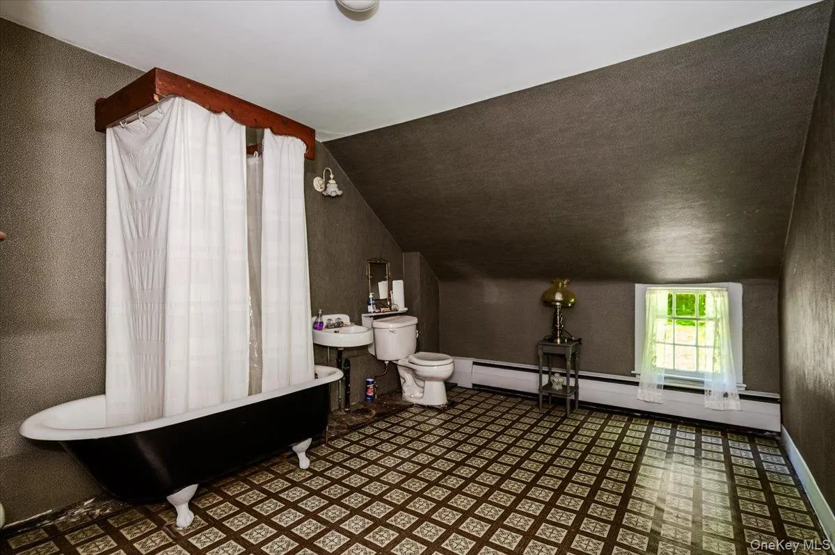 Bathroom with claw foot tub and shower combination. Bathroom with claw foot tub and shower combination.