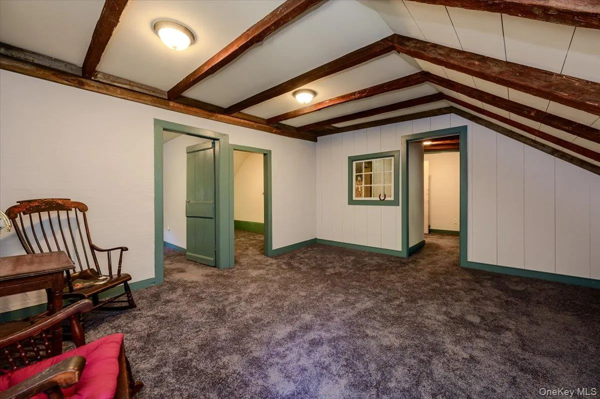 Wood beams in ceiling with original wood moldings, paneled walls and doors. Wood beams in ceiling with original wood moldings, paneled walls and doors.