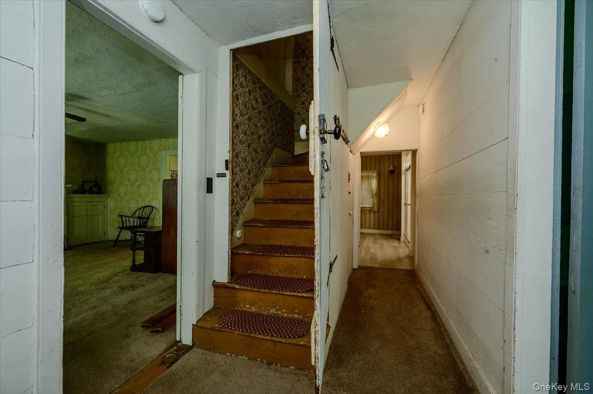 Original wood staircase and door leading to second floor. Original wood staircase and door leading to second floor.