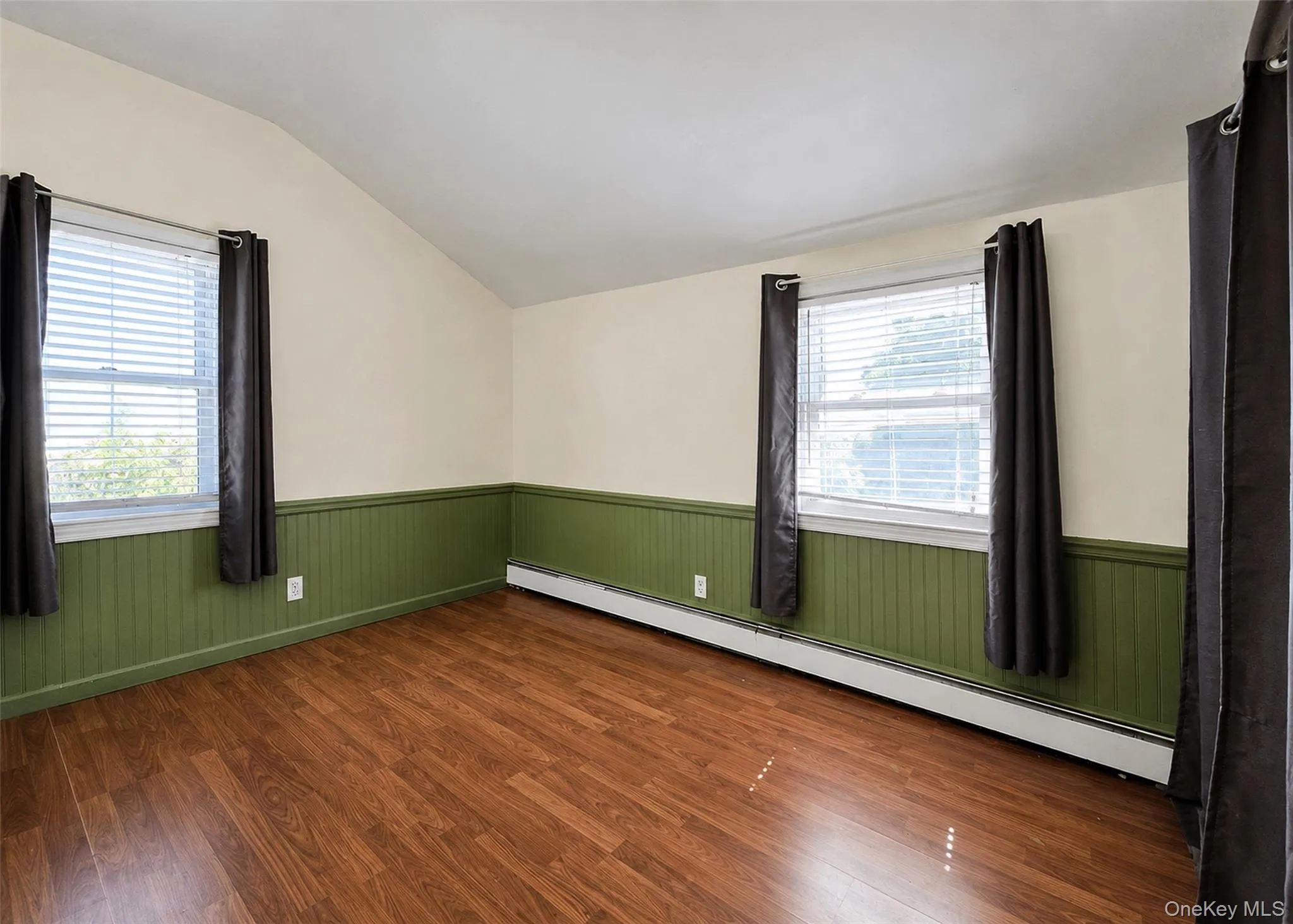 Bedroom W/Vaulted Ceiling, Laminate Wood Flooring, Wainscotting, & Ample Closet Space. Bedroom W/Vaulted Ceiling, Laminate Wood Flooring, Wainscotting, & Ample Closet Space.
