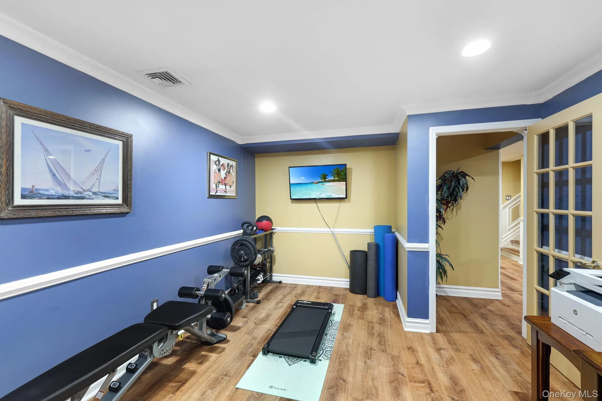 Office/gym Versatile bonus room featuring wood-finish style flooring, recessed lighting, and crown molding Office/gym Versatile bonus room featuring wood-finish style flooring, recessed lighting, and crown molding