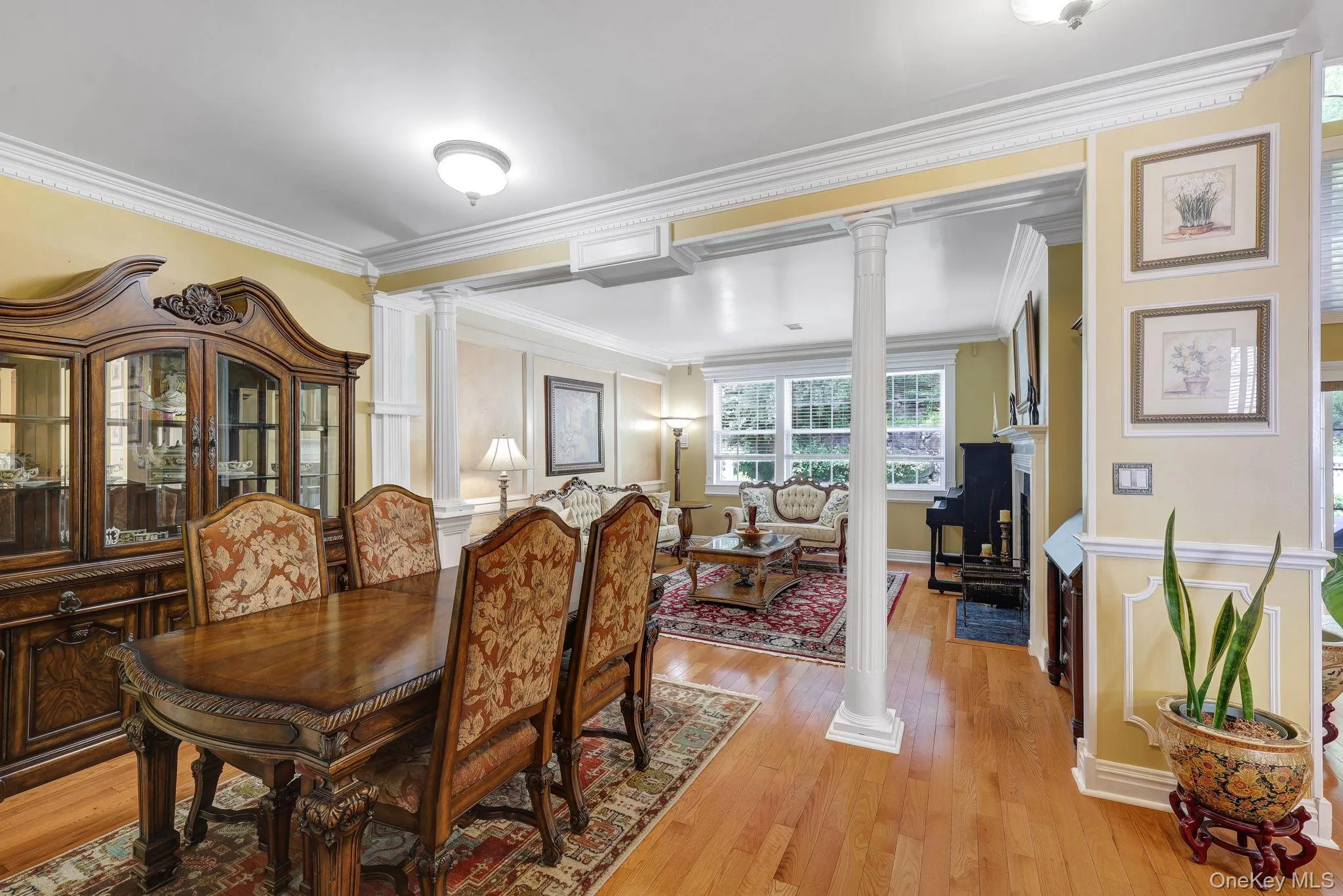 Hardwood flooring extending throughout the space with architectural pillars defining separate areas Hardwood flooring extending throughout the space with architectural pillars defining separate areas