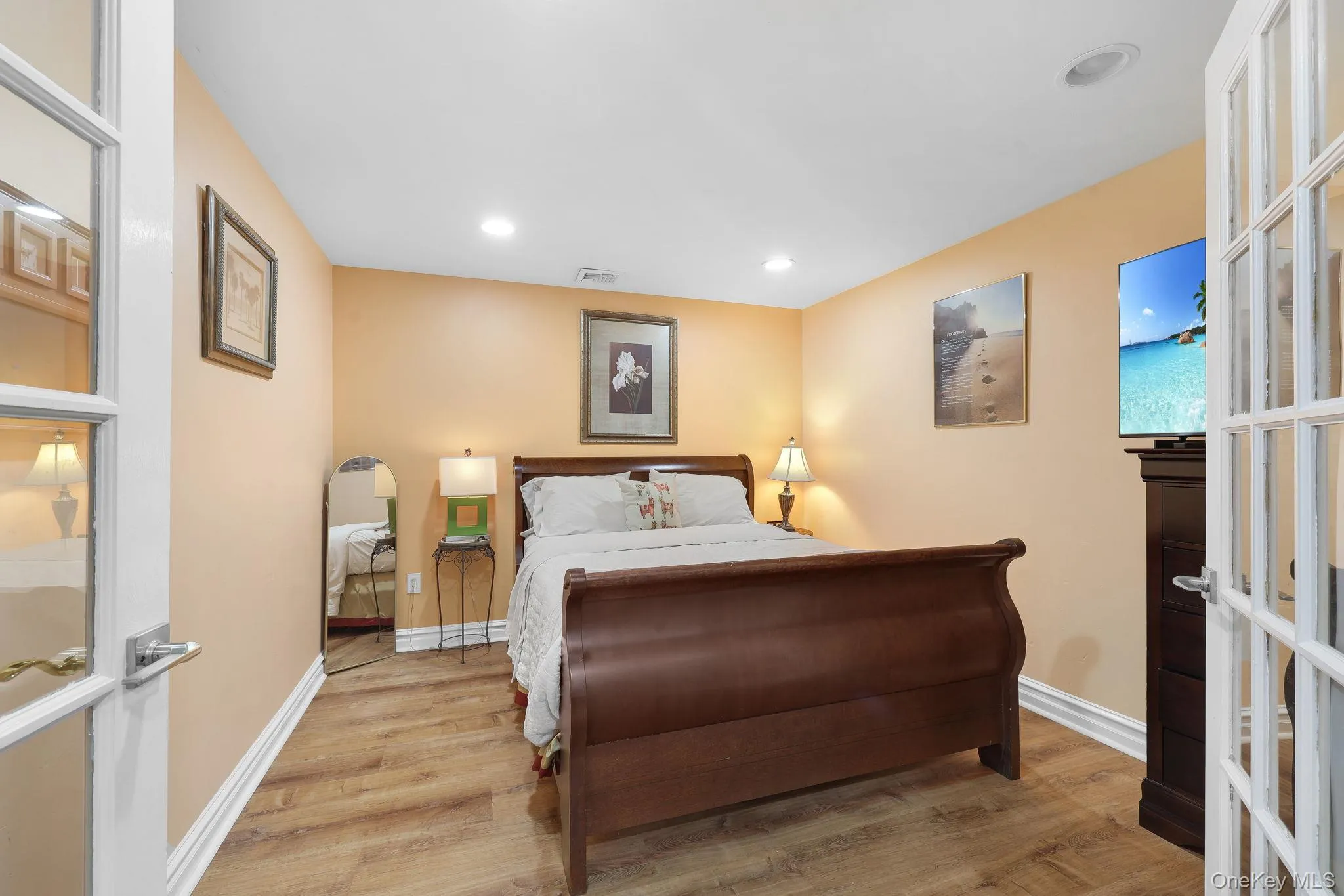 Hobby/Bonus Room featuring light wood-finish flooring, recessed lighting, and neutral wall tones and French doors Hobby/Bonus Room featuring light wood-finish flooring, recessed lighting, and neutral wall tones and French doors