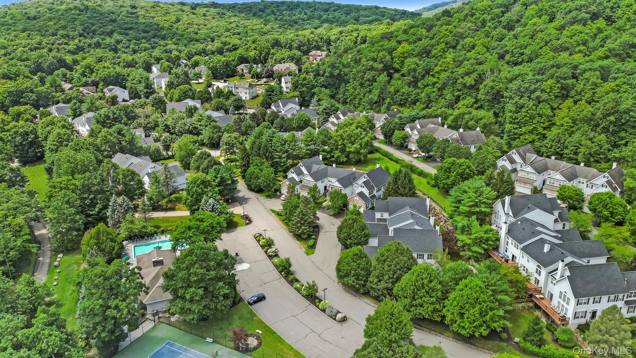 Community setting featuring residential structures, mature trees, a swimming pool, and a tennis court Community setting featuring residential structures, mature trees, a swimming pool, and a tennis court