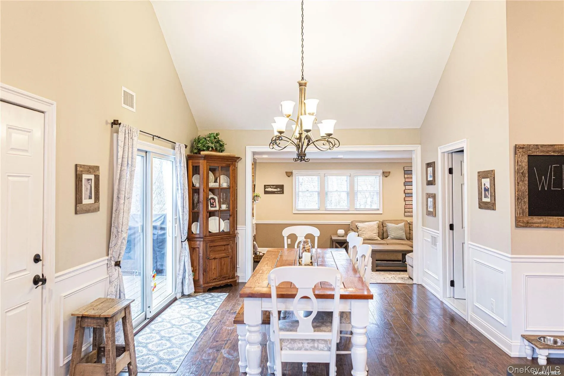 Large open dining space with vaulted ceilings & glass sliders to large deck Large open dining space with vaulted ceilings & glass sliders to large deck