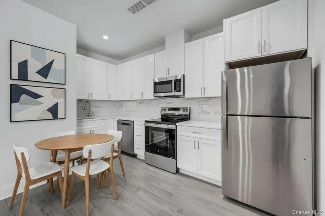 Kitchen w/ Quartz countertops, White Cabinets & Stainless-Steel Appliances - Virtually Staged Kitchen w/ Quartz countertops, White Cabinets & Stainless-Steel Appliances - Virtually Staged