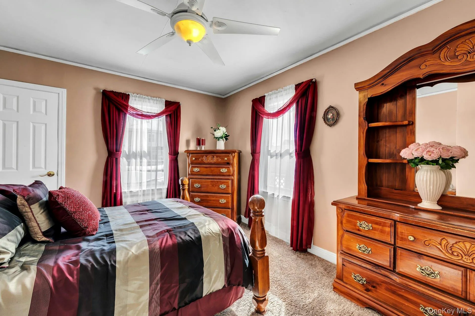 Warmly painted walls complement the carpeted flooring in this room featuring a ceiling fan with integrated lighting Warmly painted walls complement the carpeted flooring in this room featuring a ceiling fan with integrated lighting