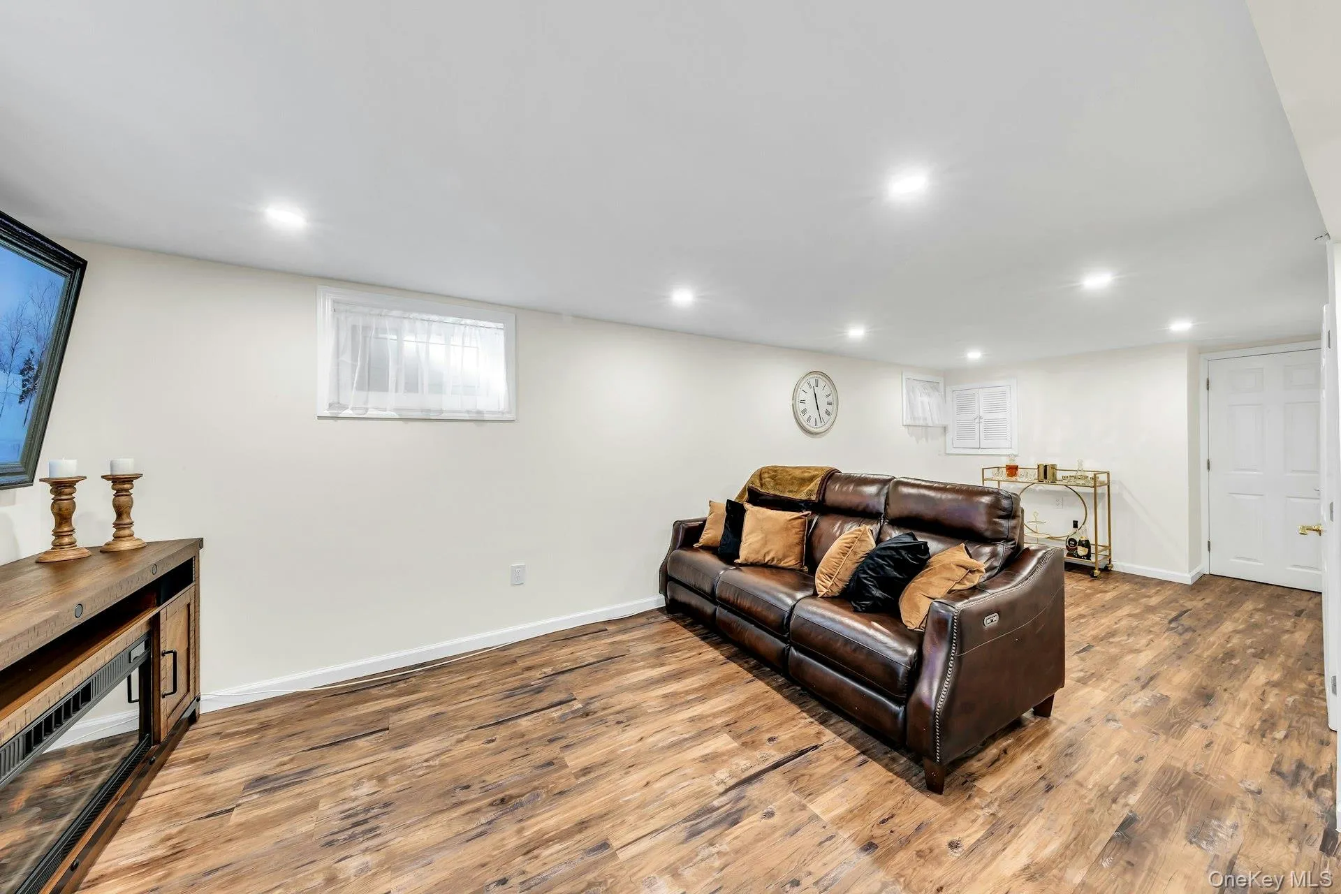 Finished room with recessed lighting and wood-finish flooring Finished room with recessed lighting and wood-finish flooring