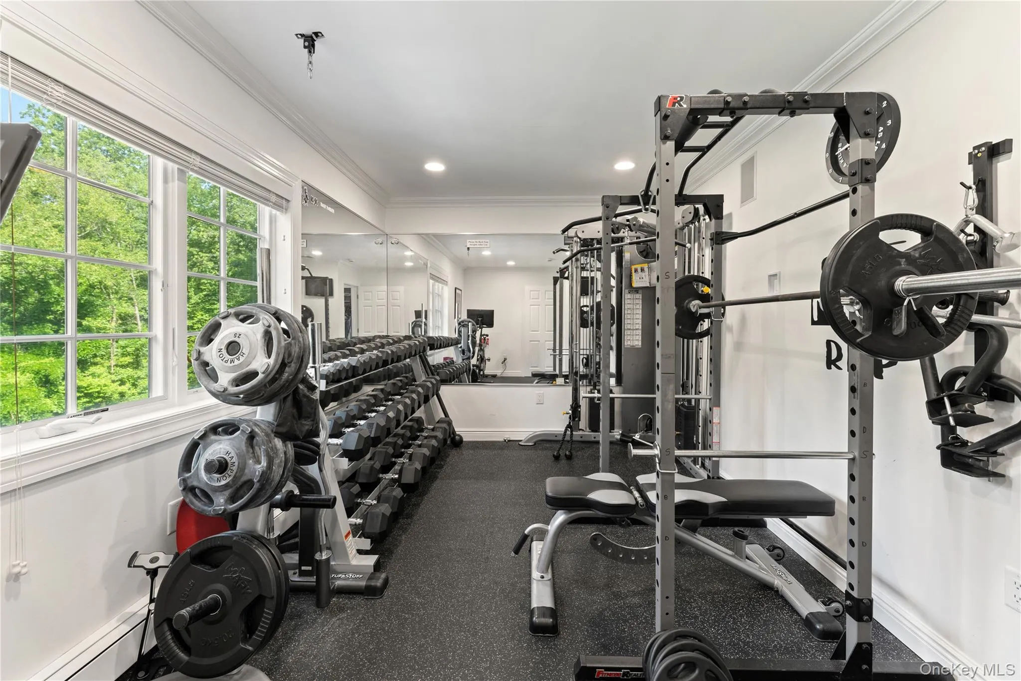 Exercise room with gym flooring overlooking the backyard or potential nursery Exercise room with gym flooring overlooking the backyard or potential nursery