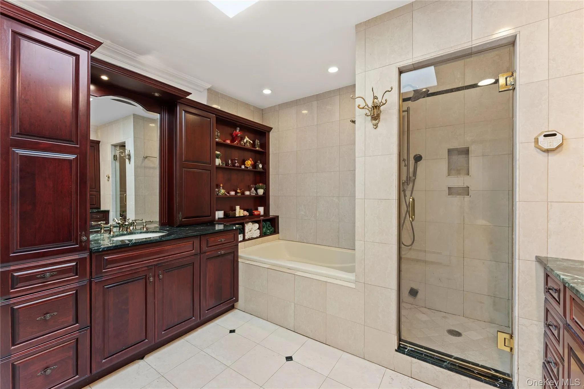 Primary bathroom with stall shower, jacuzzi tub, steam shower and two vanities Primary bathroom with stall shower, jacuzzi tub, steam shower and two vanities
