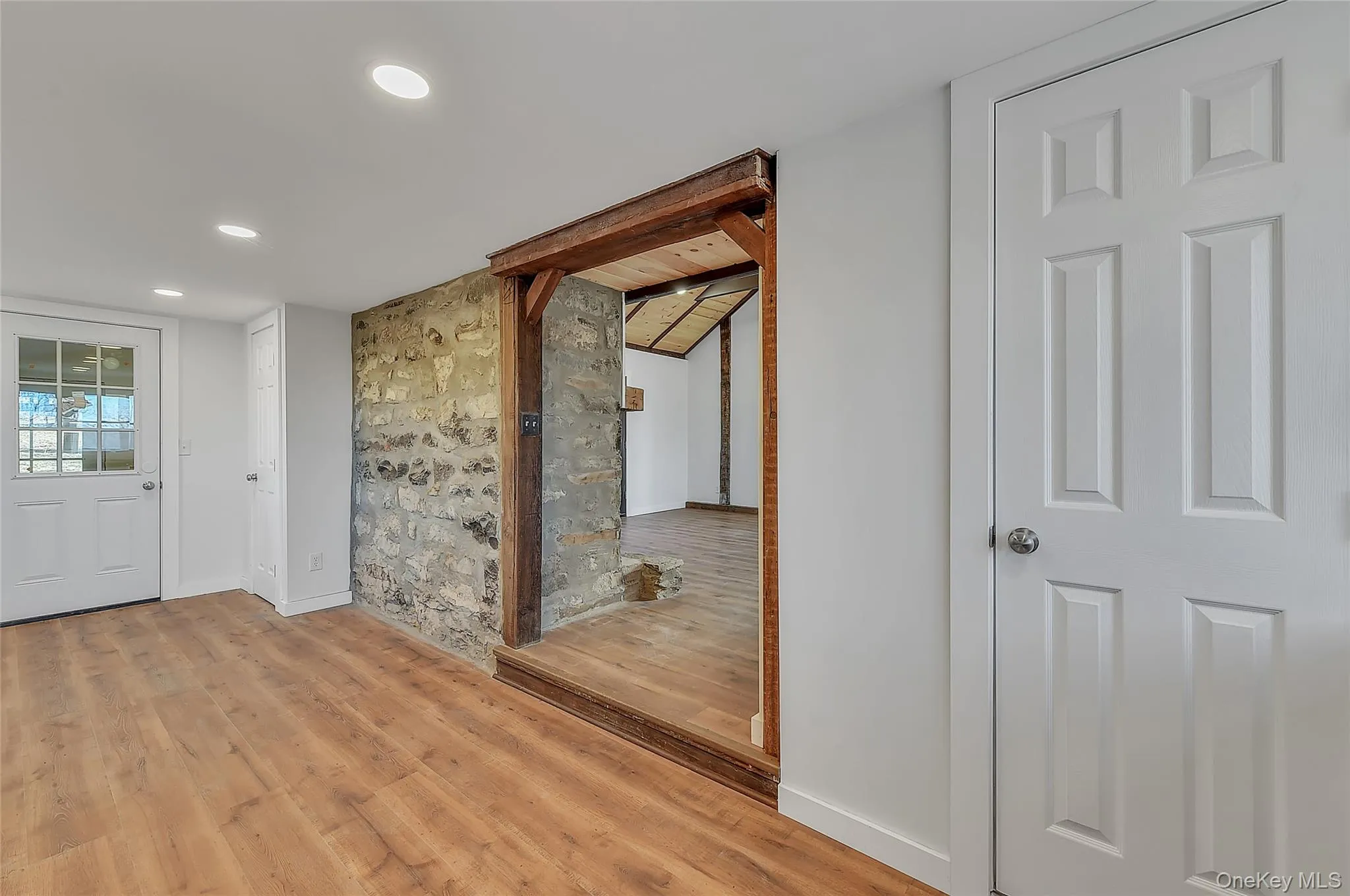Foyer entrance featuring wood finished floors and recessed lighting Foyer entrance featuring wood finished floors and recessed lighting