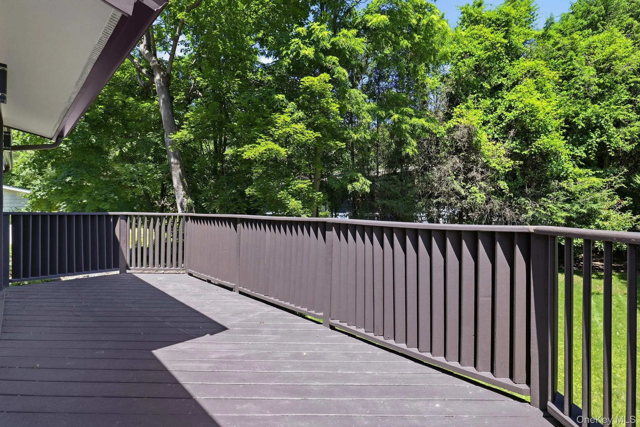 Large deck overlooking the private backyard Large deck overlooking the private backyard