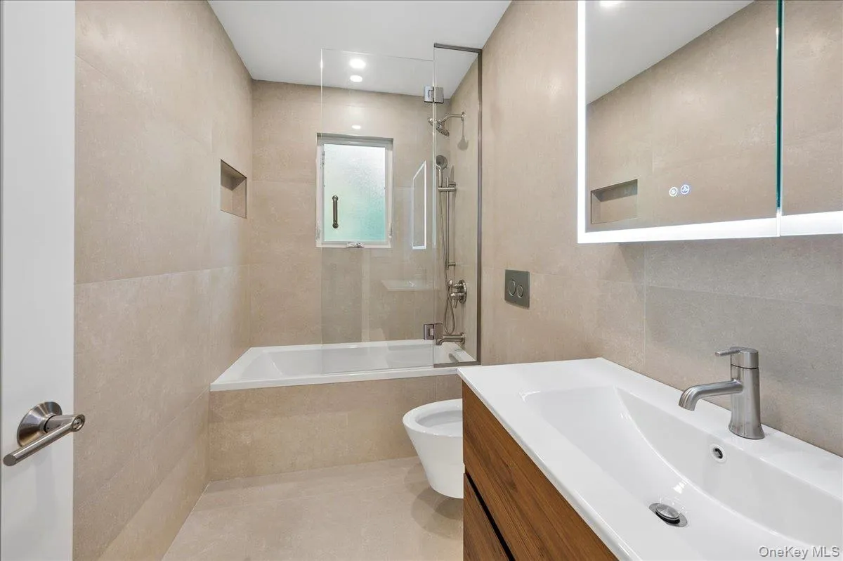 This brand new hall bath has a tub and services the two family bedrooms. This brand new hall bath has a tub and services the two family bedrooms.