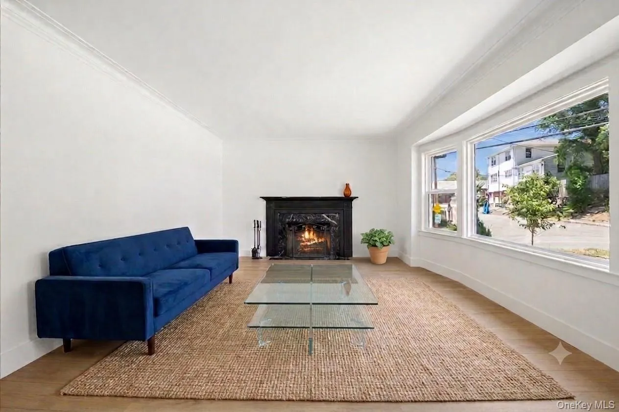 VIRTUALLY STAGED. The living room has an oversize window overlooking the sunny yard. VIRTUALLY STAGED. The living room has an oversize window overlooking the sunny yard.