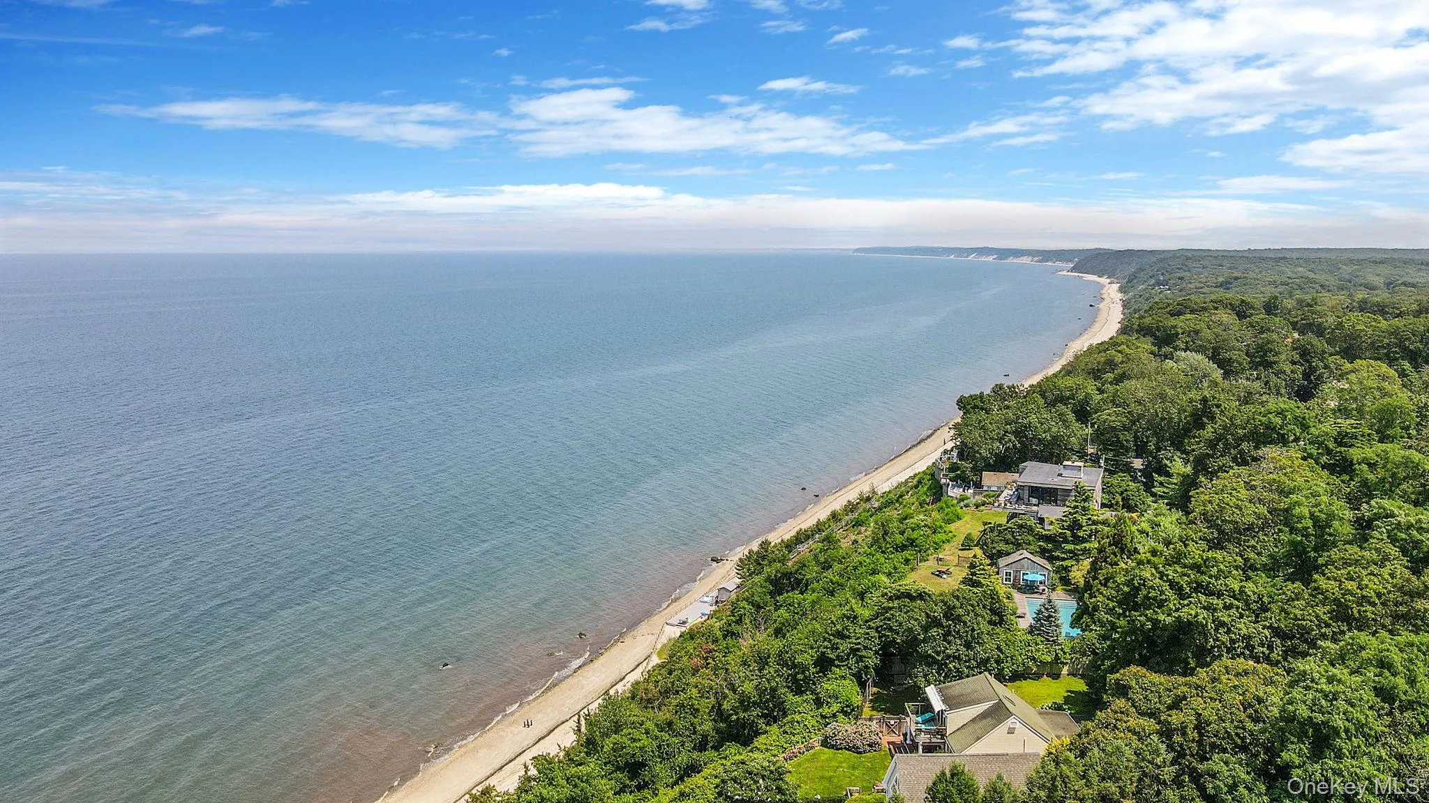 Bird's eye view of a nearby body of water and a heavily wooded area Bird's eye view of a nearby body of water and a heavily wooded area