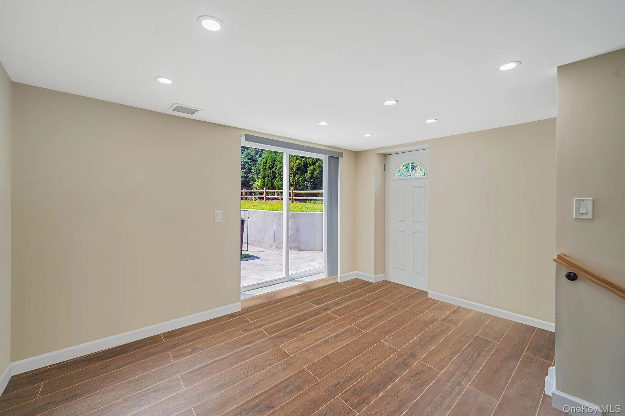 Unfurnished room with wood finished floors and recessed lighting Unfurnished room with wood finished floors and recessed lighting