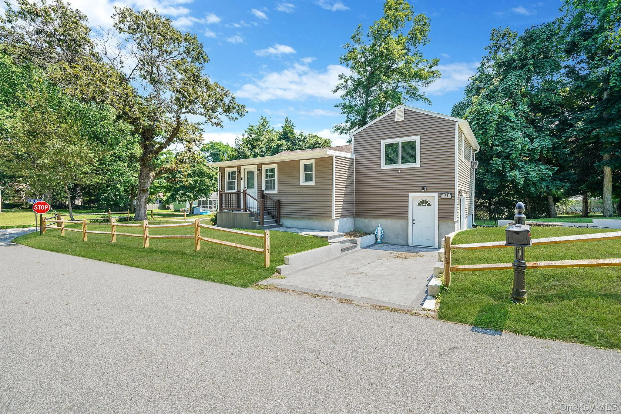 Split level home featuring a front lawn Split level home featuring a front lawn